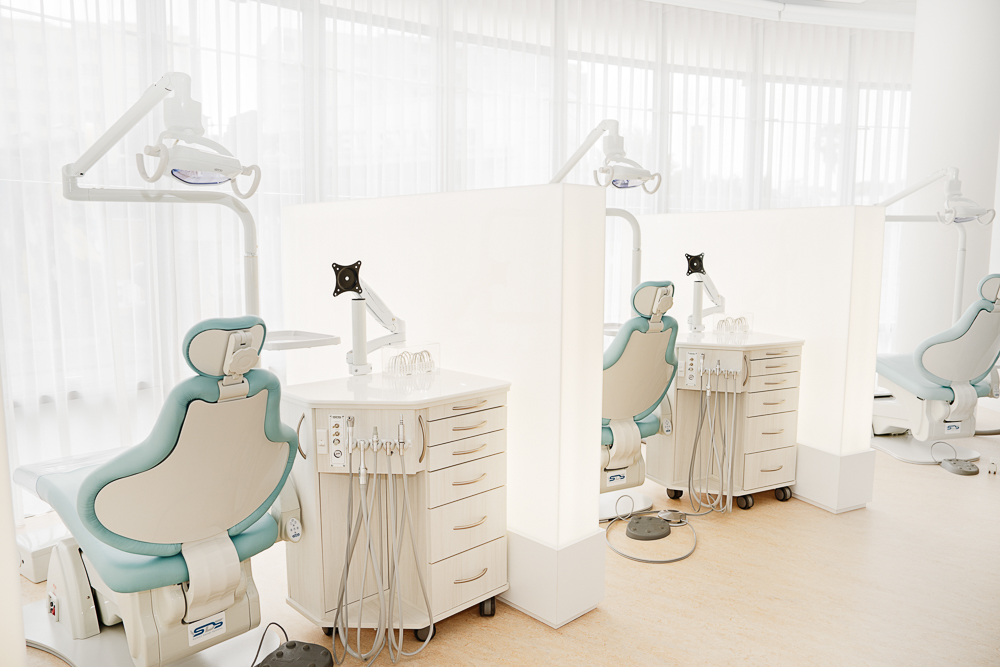 Two treatment stations with pale blue chairs at Milk Orthodontics