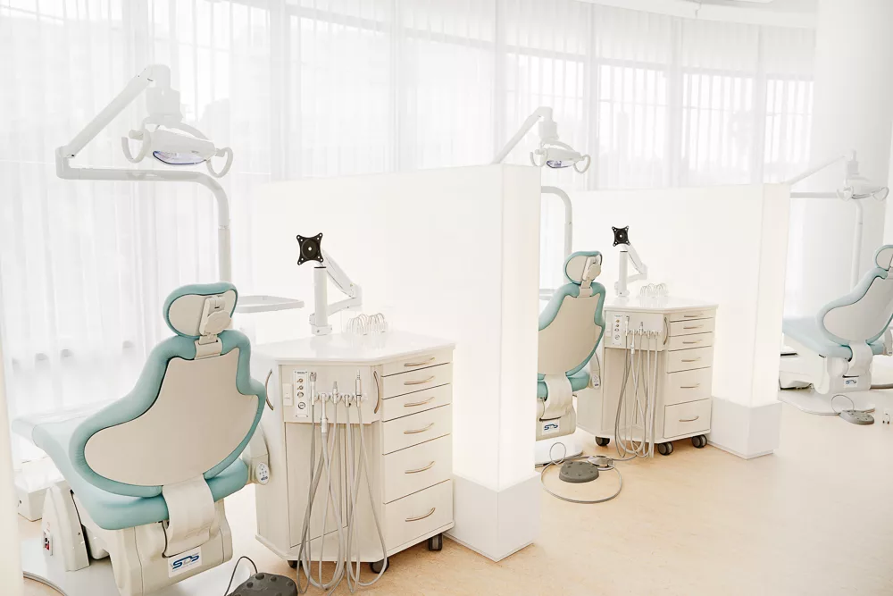Two treatment stations with pale blue chairs at Milk Orthodontics