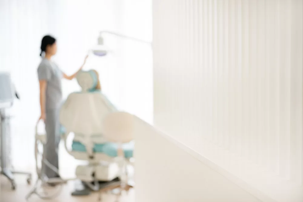 A Milk Orthodontics clinician preparing a treatment light