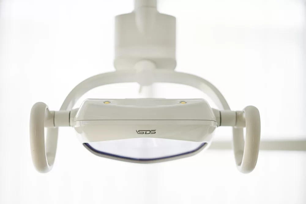 Overhead treatment light in a Milk Orthodontics treatment bay